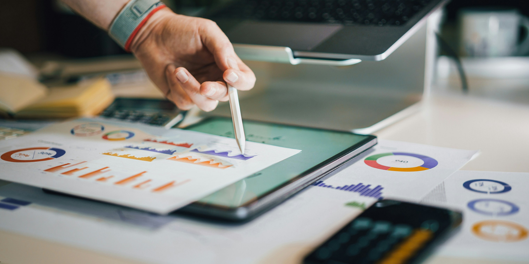 Image of someone's hand pointing at a graph using a pencil Image of someone's hand pointing at a graph using a pencil