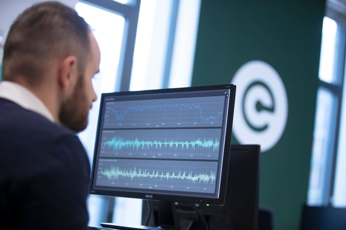 A man at work looking at a screen, working on data science points for their project