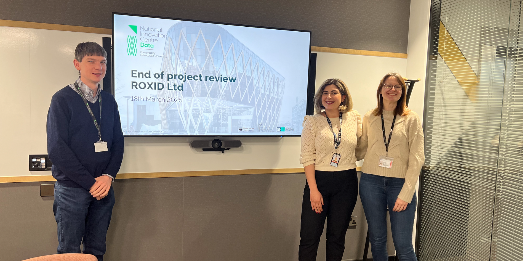 Image of Dr Chris Wedge, Roxana Montazerian and Dr Georgia Atkinson in front of a TV screen for the end of project review session