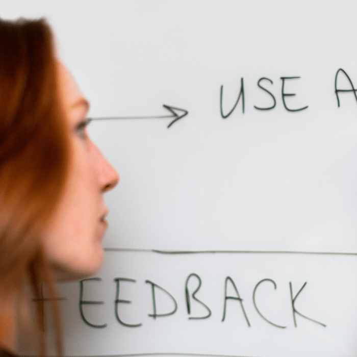 Close-up of woman writing on a whiteboard